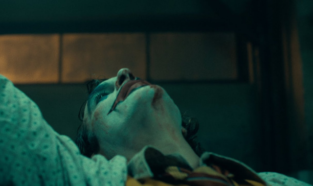 The Joker Has A Bloody Poster & A Maniacal Trailer